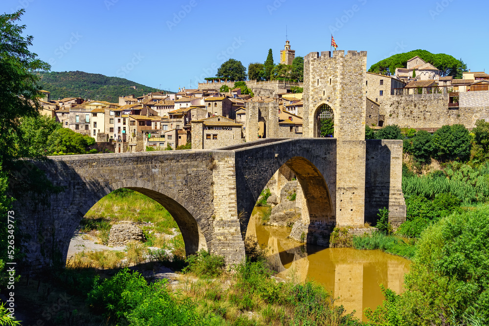 Stone bridge over the river at the entrance of the medieval town of Besalu, in Girona, Catalonia.