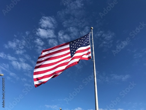 Flag USA with pole in sky. Photo