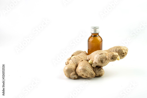 Ginger herb and ginger essential oil bottle isolated on white background.