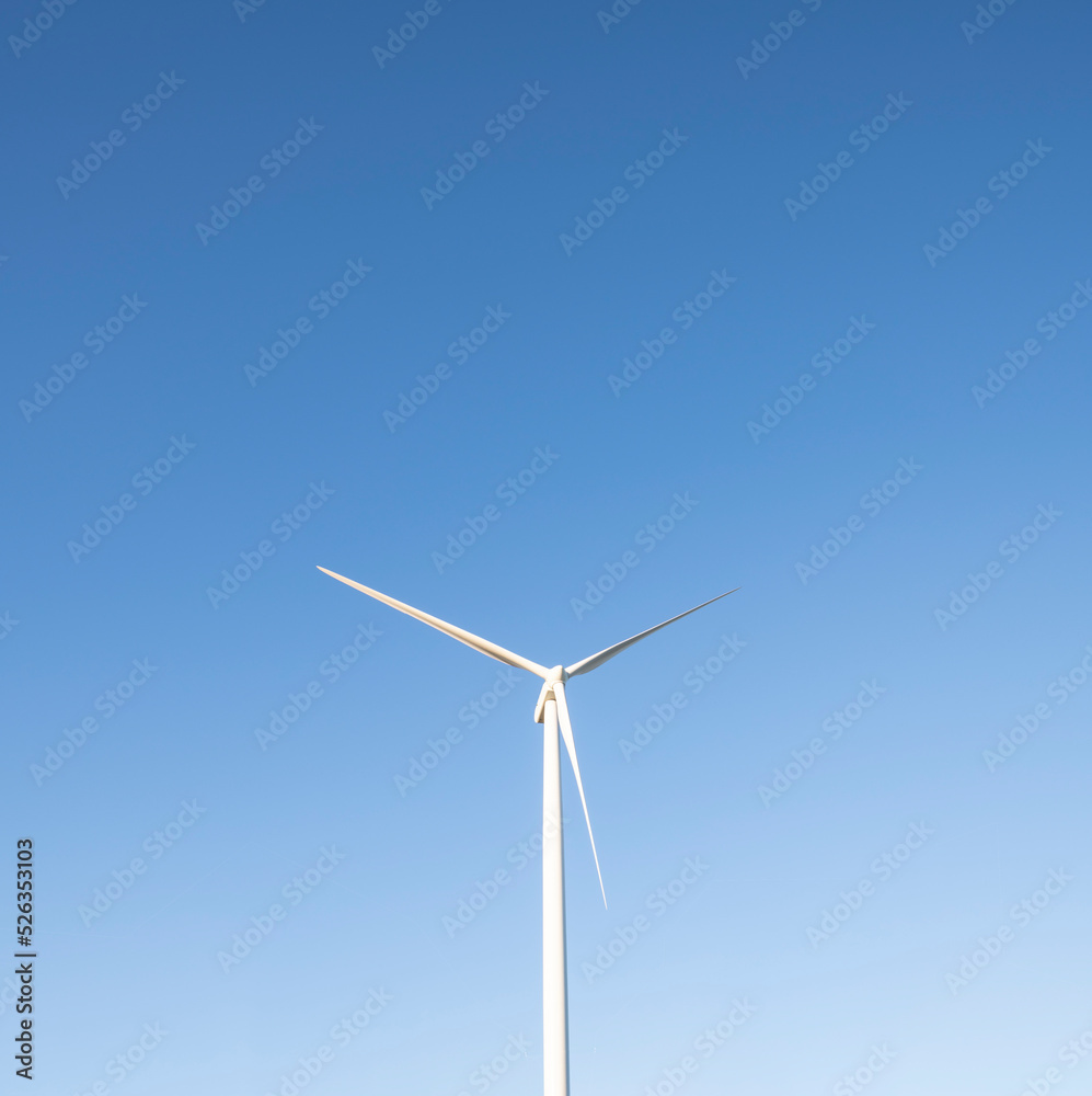 Isolated Wind Turbine against clear blue sky with copy space Isolated Wind Turbine against clear blue sky with copy space