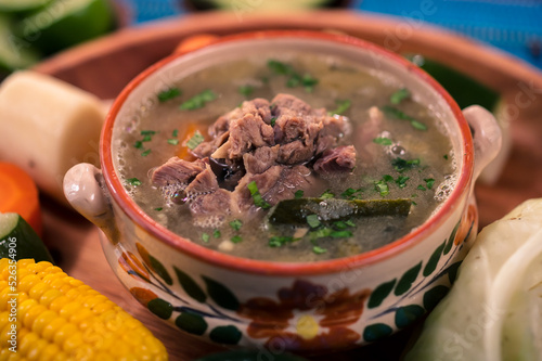 Delicious beef broth, a traditional dish made with beef bone and vegetables. photo