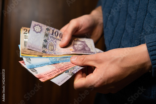 close-up on Hungarian forints held in hands. Hungarian economics and finance