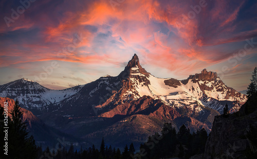 Beautiful sunrise or sunset over mountain peak at the Montana-Wyoming border in the western USA like fire in the sky in the clouds
