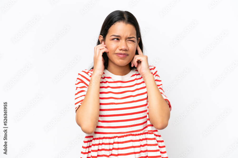 Young Colombian woman isolated on white background frustrated and covering ears Young Colombian woman isolated on white background frustrated and covering ears