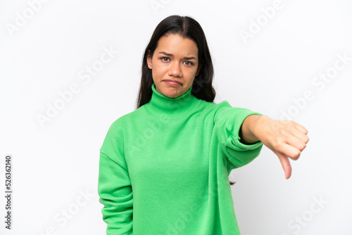 Young Colombian woman isolated on white background showing thumb down with negative expression