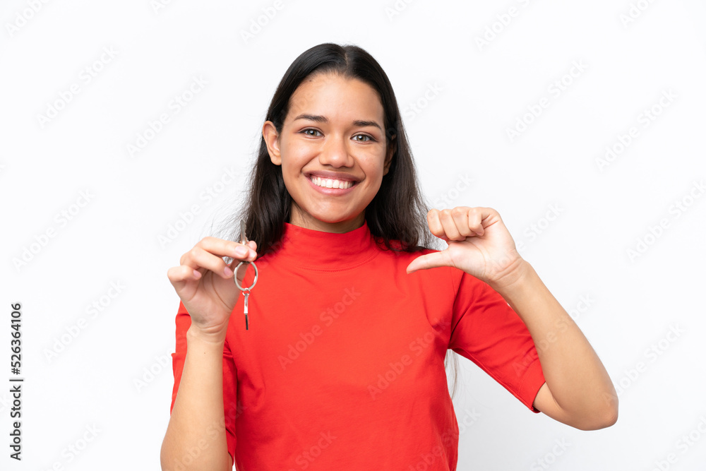 Young Colombian woman holding home keys isolated on white background proud and self-satisfied Young Colombian woman holding home keys isolated on white background proud and self-satisfied