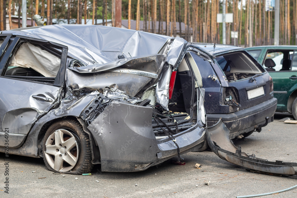 Broken car after a traffic accident in the parking lot of a repair station.  Car body