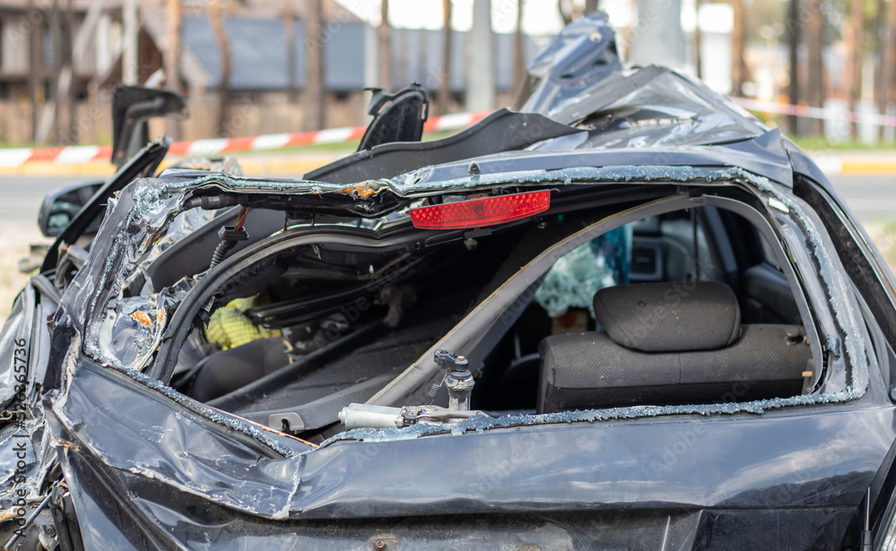 Shot car during the war in Ukraine. A car after an accident with a broken rear window. The wreckage of the interior of a modern car after an accident, a detailed close-up view of the damaged car.