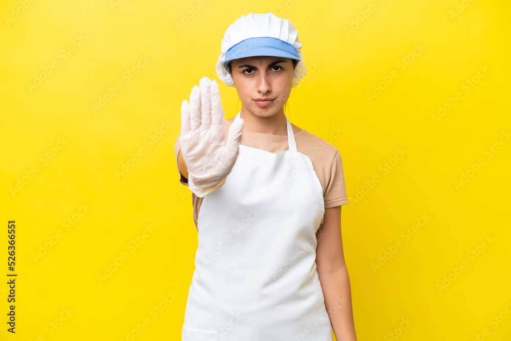 Fishwife woman over isolated background making stop gesture