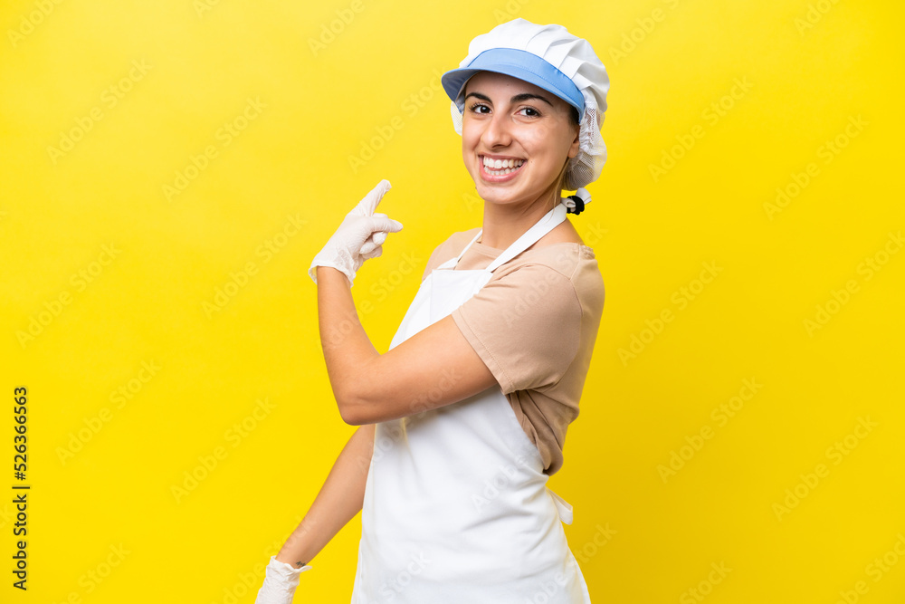 Fishwife woman over isolated background pointing back Fishwife woman over isolated background pointing back