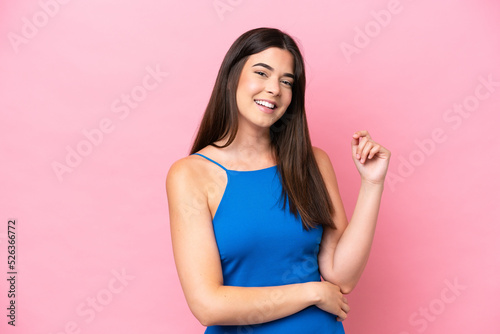Young Brazilian woman isolated on pink background laughing