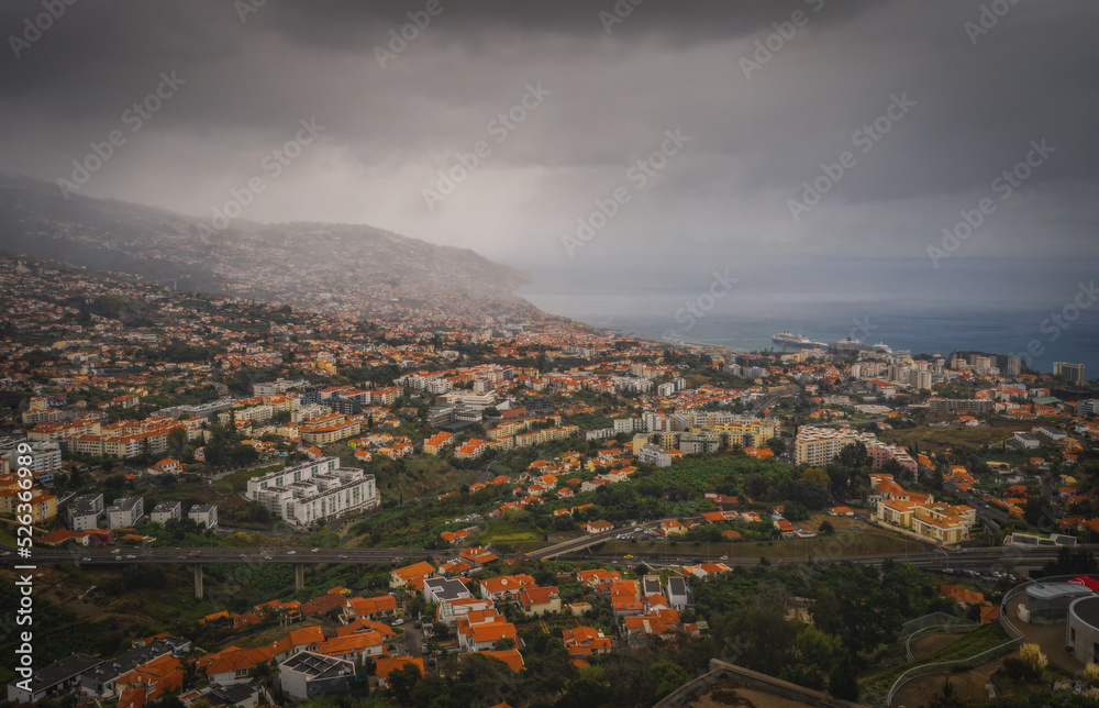 Aerial panoramic view of Funchal city, Madeira, Portugal in foggy and rainy weather. October 2021