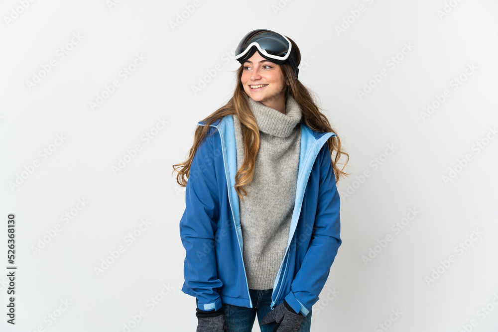 Skier girl with snowboarding glasses isolated on white background looking to the side and smiling Skier girl with snowboarding glasses isolated on white background looking to the side and smiling