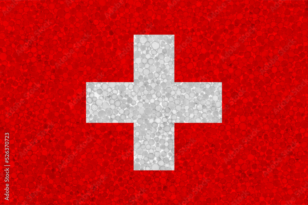 Flag of Switzerland on styrofoam texture. national flag painted on the surface of plastic foam Flag of Switzerland on styrofoam texture. national flag painted on the surface of plastic foam