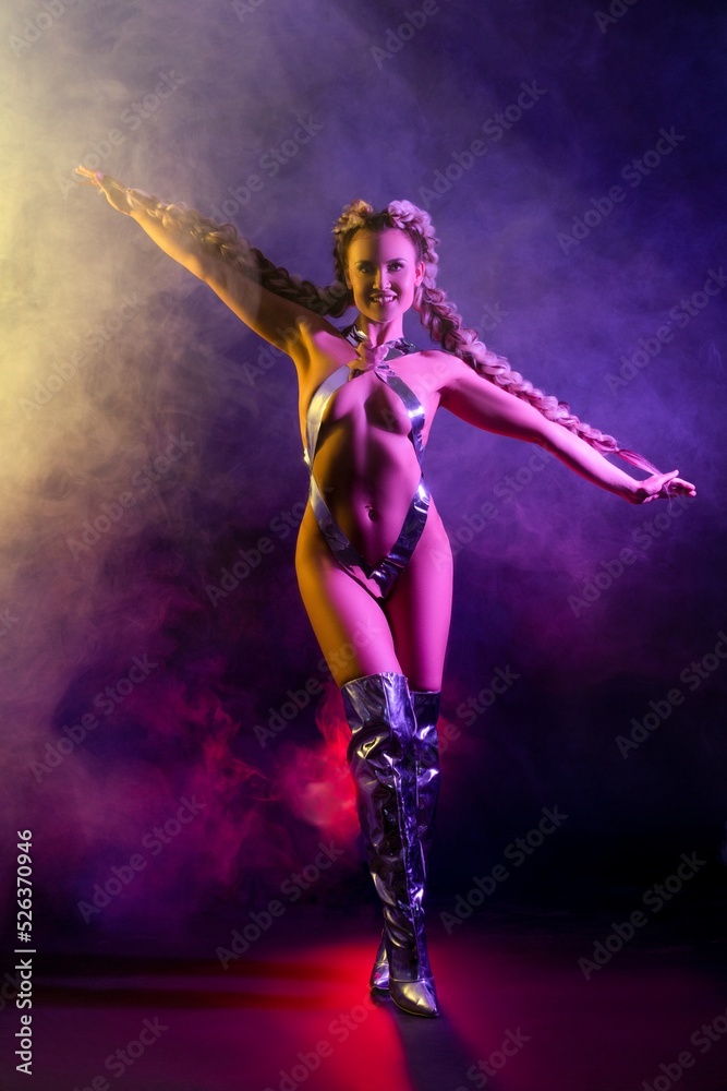 Cheerful female dancer in underwear under neon light
