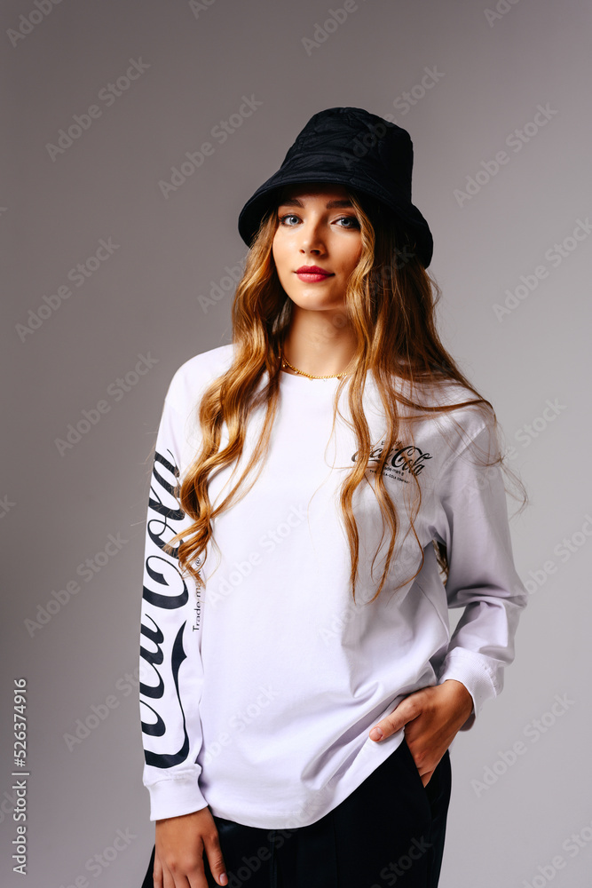 A beautiful young girl in a hat smiles mysteriously. A beautiful young girl in a hat smiles mysteriously.