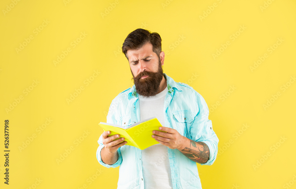 curious bearded man with planner on yellow background, daily planning curious bearded man with planner on yellow background, daily planning