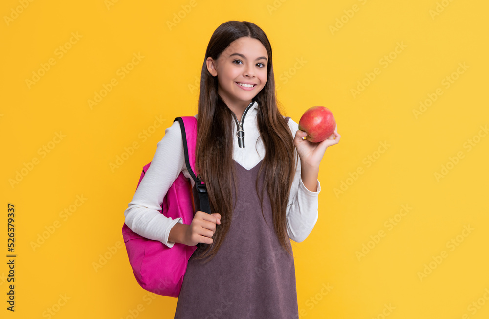 happy child with school backpack and apple on yellow background happy child with school backpack and apple on yellow background