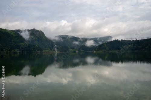 Clouds and hills reflecting in Lake Furnas