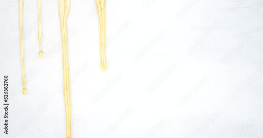 dripping drops of golden cannabis wax, marijuana extract rosin on a white background. High quality 4k footage