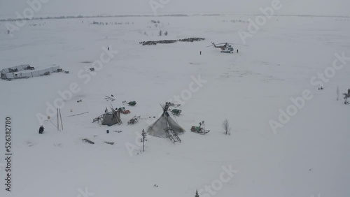 An expedition with a helicopter visited the small northern peoples in the Arctic in winter. Aerial view