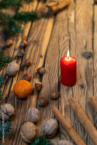 Traditional Czech Christmas on wood decoration with twig, candle, apple, orange, fruit