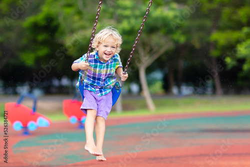 Child on playground. swing Kids play outdoor. © famveldman