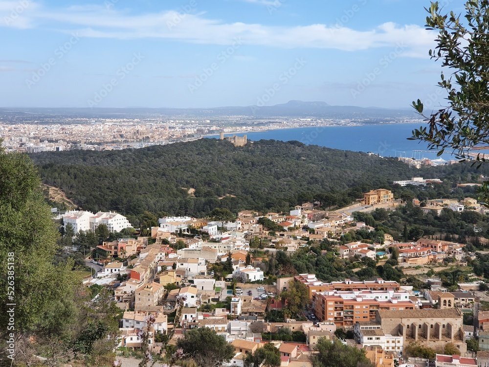 Naklejka premium View of Genova, Mallorca, Balearic Islands, Spain, with the Castel Belver in the middle of the picture and Palma de Mallorca in the background