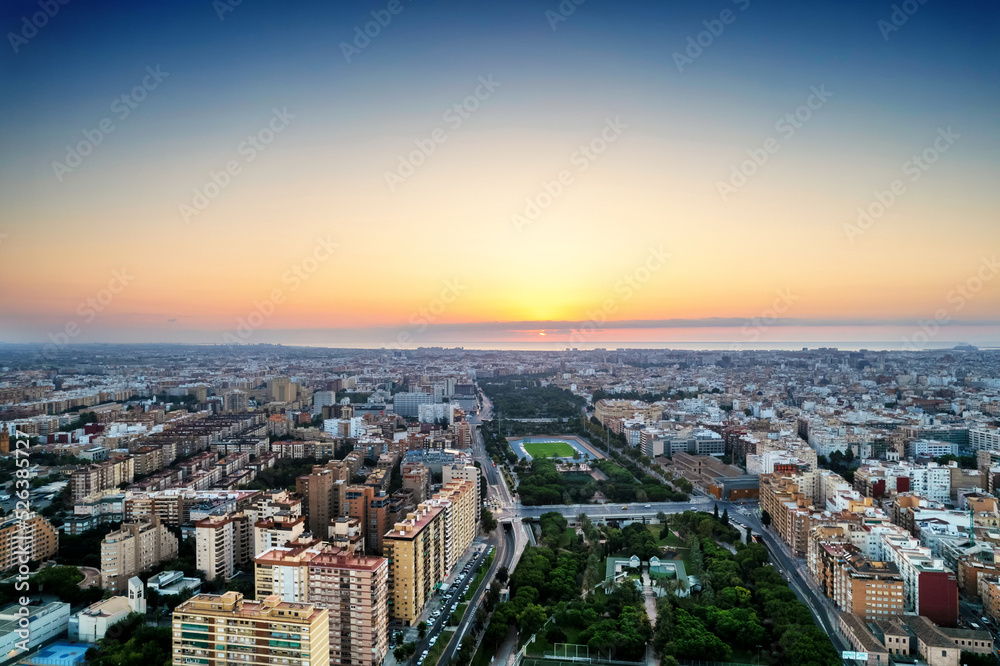 Fototapeta premium Aerial drone view of sunrise over Turia Gardens, a riverbed turned into a park, in Valencia, Spain