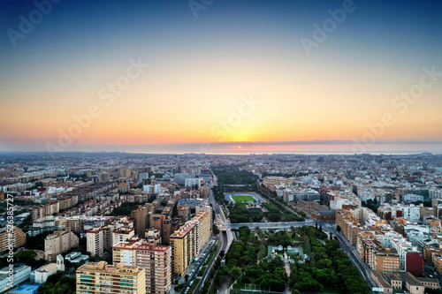 Aerial drone view of sunrise over Turia Gardens, a riverbed turned into a park, in Valencia, Spain © Allen.G