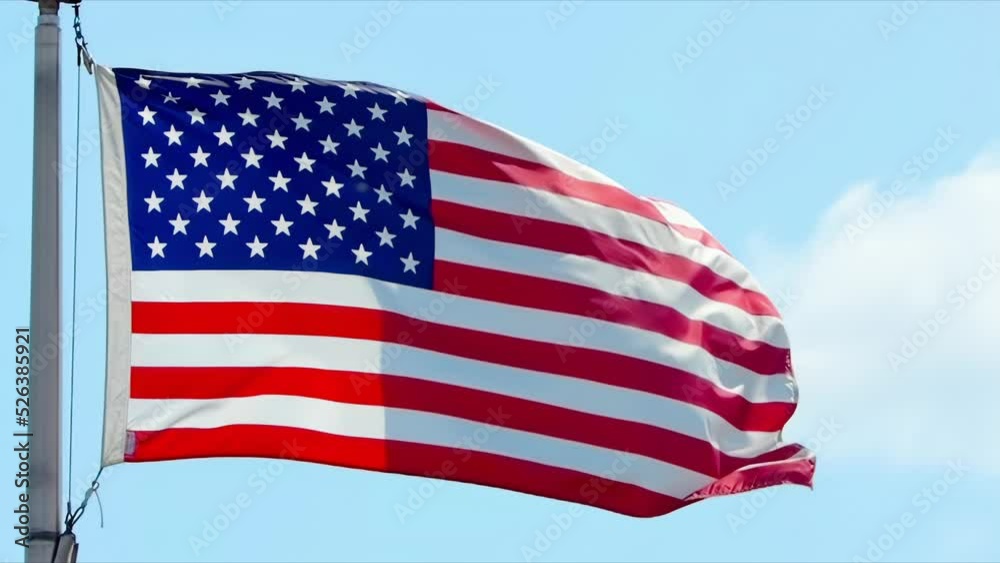 A slow-motion of a waving United States of America flag during a sunny day.
