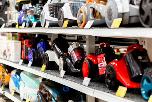 Assortment of vacuum cleaners on the showcase of the electronic store