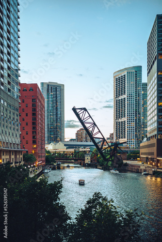 A boat on the Chicago River in the afternoon among the buildings (ID: 526395147)