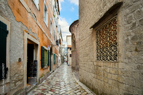 A narrow stone alley alongside the The Cathedral of Saint Tryphon in Kotor, Montenegro. photo