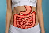 Woman with image of healthy digestive system on blue background, closeup