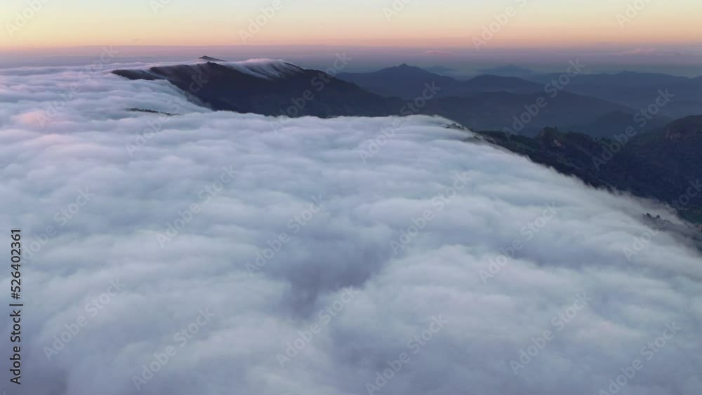 A sea of ​​mist flowing across the mountain at Phu Chi Fa Viewpoint, bordering Thailand with Laos in Chiang Rai Province, Thailand.