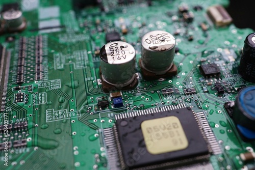 A semiconductor on a printed circuit board wet from the rain.Image: recession, bankruptcy.