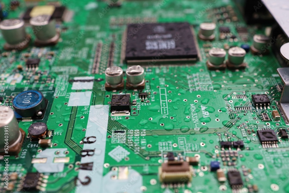 A semiconductor on a printed circuit board wet from the rain.Image: recession, bankruptcy. A semiconductor on a printed circuit board wet from the rain.Image: recession, bankruptcy.