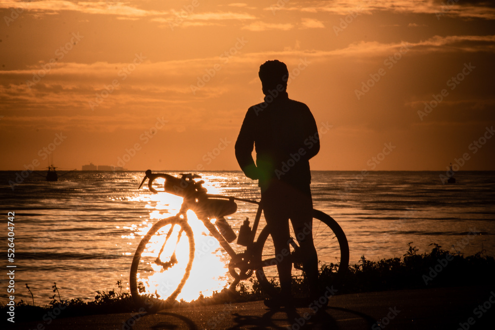 Fototapeta premium silhouette of a person riding a bike