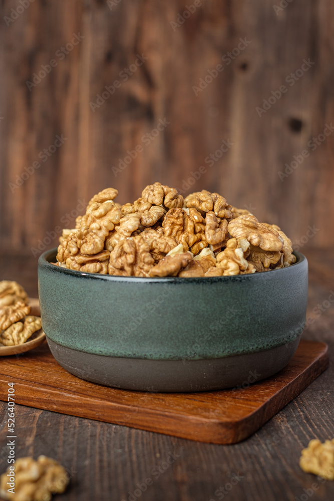 walnut in ceramic bowl on wooden tray in kiechen table walnut in ceramic bowl on wooden tray in kiechen table