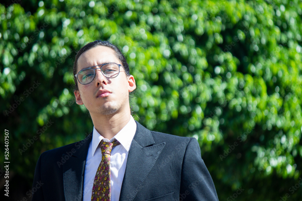 Handsome and elegant Latin American young man poses outdoors with solid backgrounds for design, with great attitude in Venezuela Handsome and elegant Latin American young man poses outdoors with solid backgrounds for design, with great attitude in Venezuela