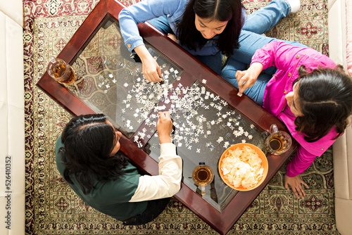 Three women doing a puzzle together