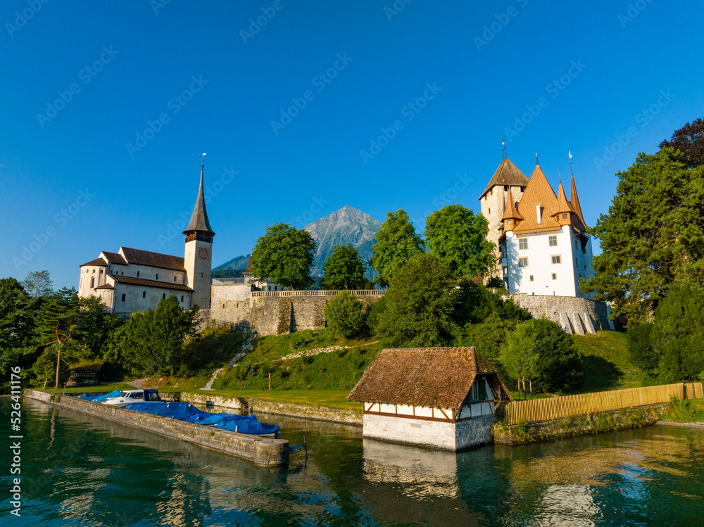 Picturesque castle and church of Spiez at lake Thun, with mount Niesen in the background, Switzerland 
