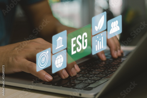 ESG environment social governance investment business concept. hand using computer laptop icon symbol of esg on virtual screen concept. business investment strategy concept.