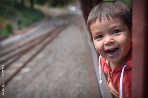 Excited 2 year old mixed race boy cheerfully rides the Walhalla historic train photo