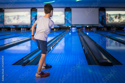 Kids 10 pin bowling under blue lights photo