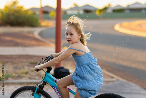 young girl riding her bike in suburbs photo