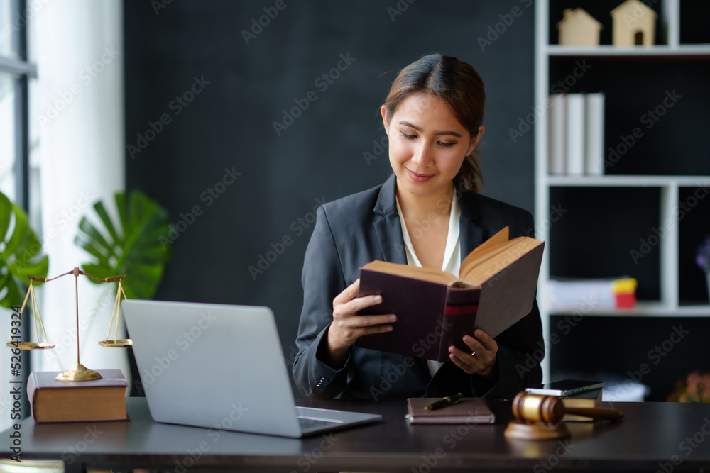 Lawyer concept. Beautiful Asian lawyer woman is reviewing various legal clauses to support the case file The results of the legal proceedings with the client. Lawyer concept. Beautiful Asian lawyer woman is reviewing various legal clauses to support the case file The results of the legal proceedings with the client.