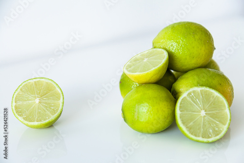 Lime fruit on white, ready to juice for cool summer drink photo