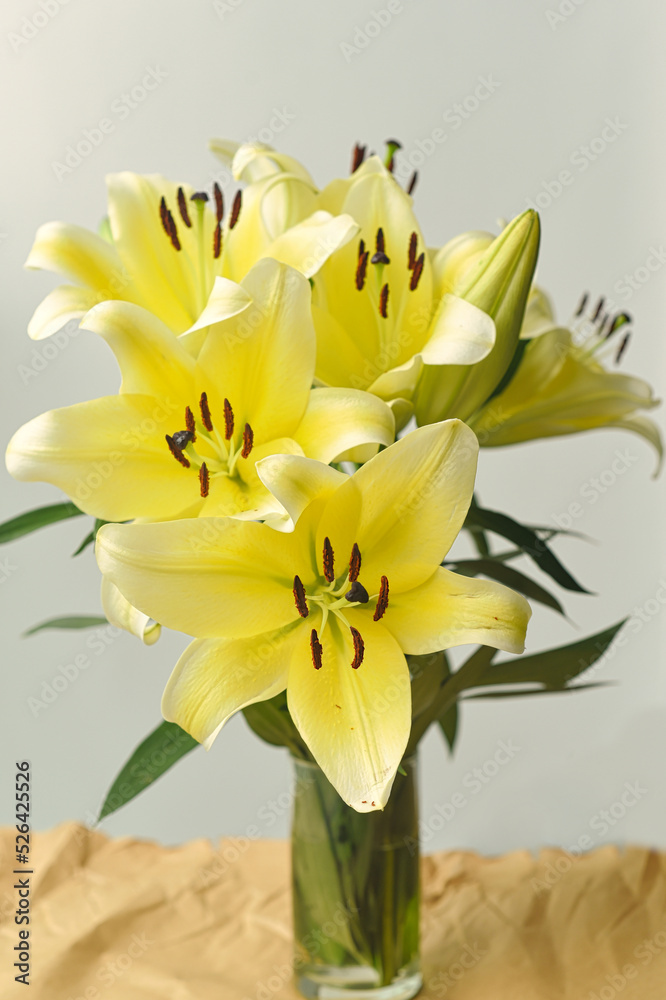 Obraz premium Yellow Lilly bouquet in a vase on white background